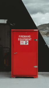Approved fuel containers stored upright in a cool, ventilated shed away from heaters and household living areas.