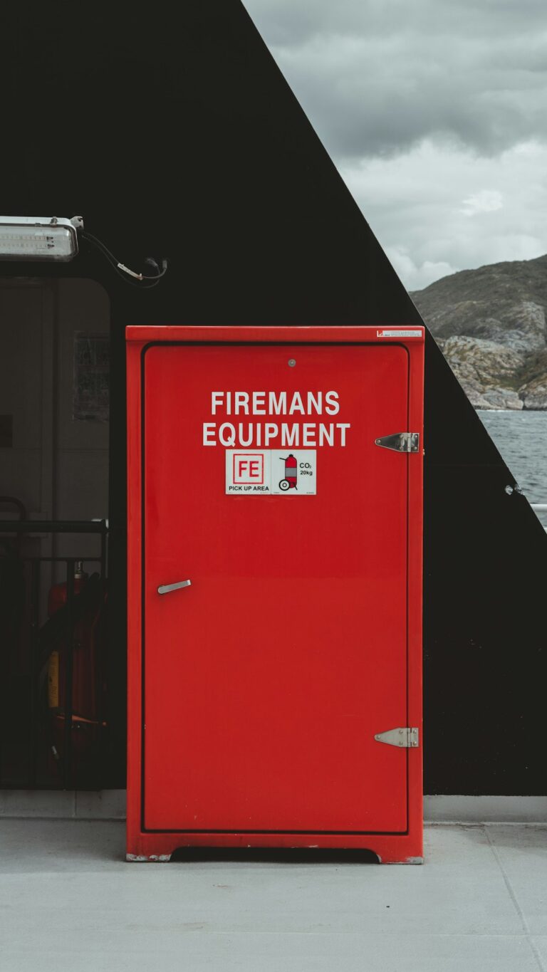 Approved fuel containers stored upright in a cool, ventilated shed away from heaters and household living areas.